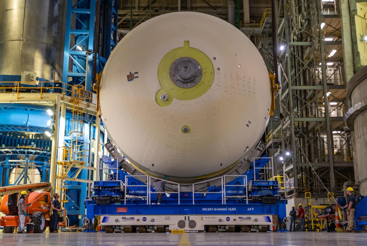 Move crews at NASA’s Michoud Assembly Facility in New Orleans perform “breakover” operations on a liquid oxygen tank in the facility’s vertical assembly building on Aug. 22, 2025. During the breakover, teams lifted the tank from its vertical configuration inside of a production cell and set it horizontally atop self-propelled mobile transporters for transfer to the final assembly production area. There, it will undergo integration of the forward dome by SLS (Space Launch System) prime contractor, Boeing. Eventually, the liquid oxygen tank will be moved back to the high bay where it will be mated with the intertank and forward skirt to complete the forward join of the Artemis III core stage. The propellant tank is one of five major elements that make up the 212-foot-tall rocket stage. The core stage, along with its four RS-25 engines, produce more than two million pounds of thrust to help launch NASA’s Orion spacecraft, astronauts, and supplies beyond Earth’s orbit and to the lunar surface for Artemis.